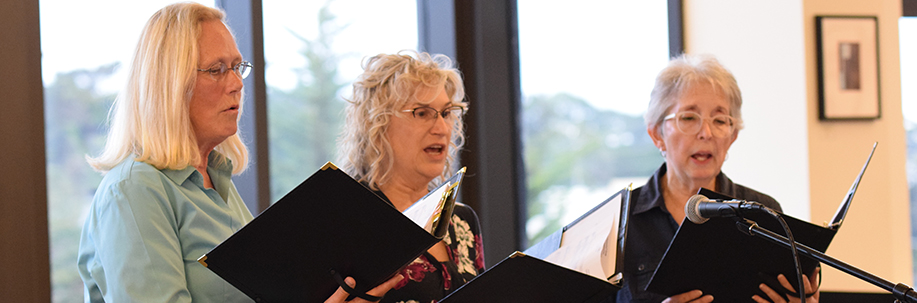 Photo of three singers on stage.