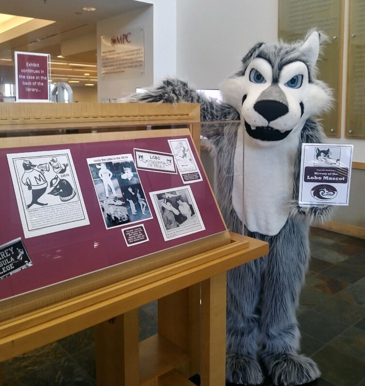 Photo of Louie in front of library exhibit 2019