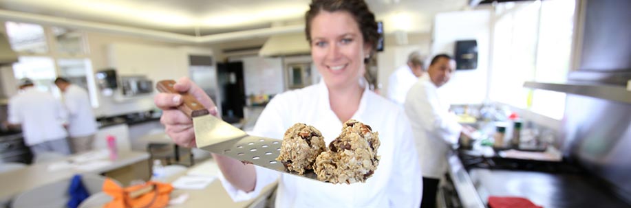 Instructor Molly Jensen baking cookies in the hospitality kitchen.